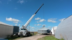 Assembling a grain bin using the crane